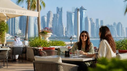 Doha skyline with West Bay towers behind a cafe terrace