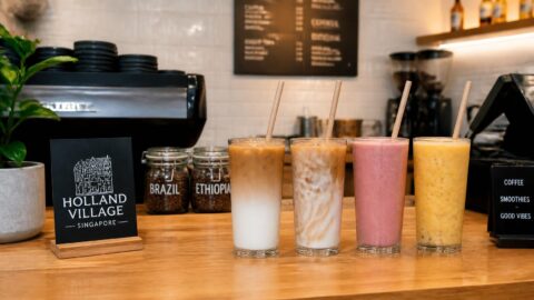 Specialty coffee counter in Holland Village, Singapore serving iced drinks with paper straws