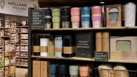 Specialty grocer shelf in Holland Village, Singapore displaying reusable coffee tumblers