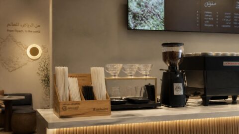 Modern cafe interior in Riyadh with paper straws on the counter