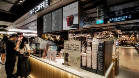 Specialty coffee kiosk in an Orchard Road mall in Singapore displaying paper cups