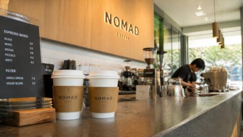 Specialty coffee paper takeaway cups on a counter in Singapore