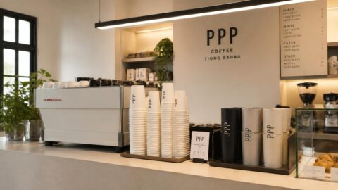 Minimalist specialty coffee counter in Tiong Bahru, Singapore displaying custom paper cups