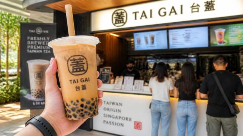Iced bubble tea with a wide sugarcane bagasse compostable straw piercing a sealed cup in Singapore