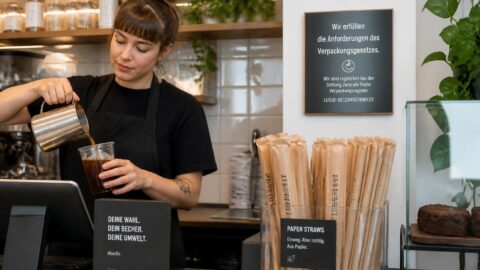 Counter in a modern German café with a dispenser of paper straws