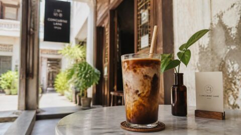 Specialty coffee with a paper straw in a chic café on Concubine Lane, Ipoh