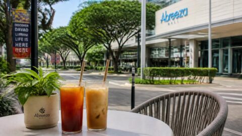 Iced beverages with paper straws at a shopping mall in Davao City with orderly streetscape in the background