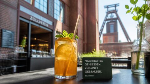 Cold beverage with a premium paper straw at a modern café inside the Zollverein complex in Essen